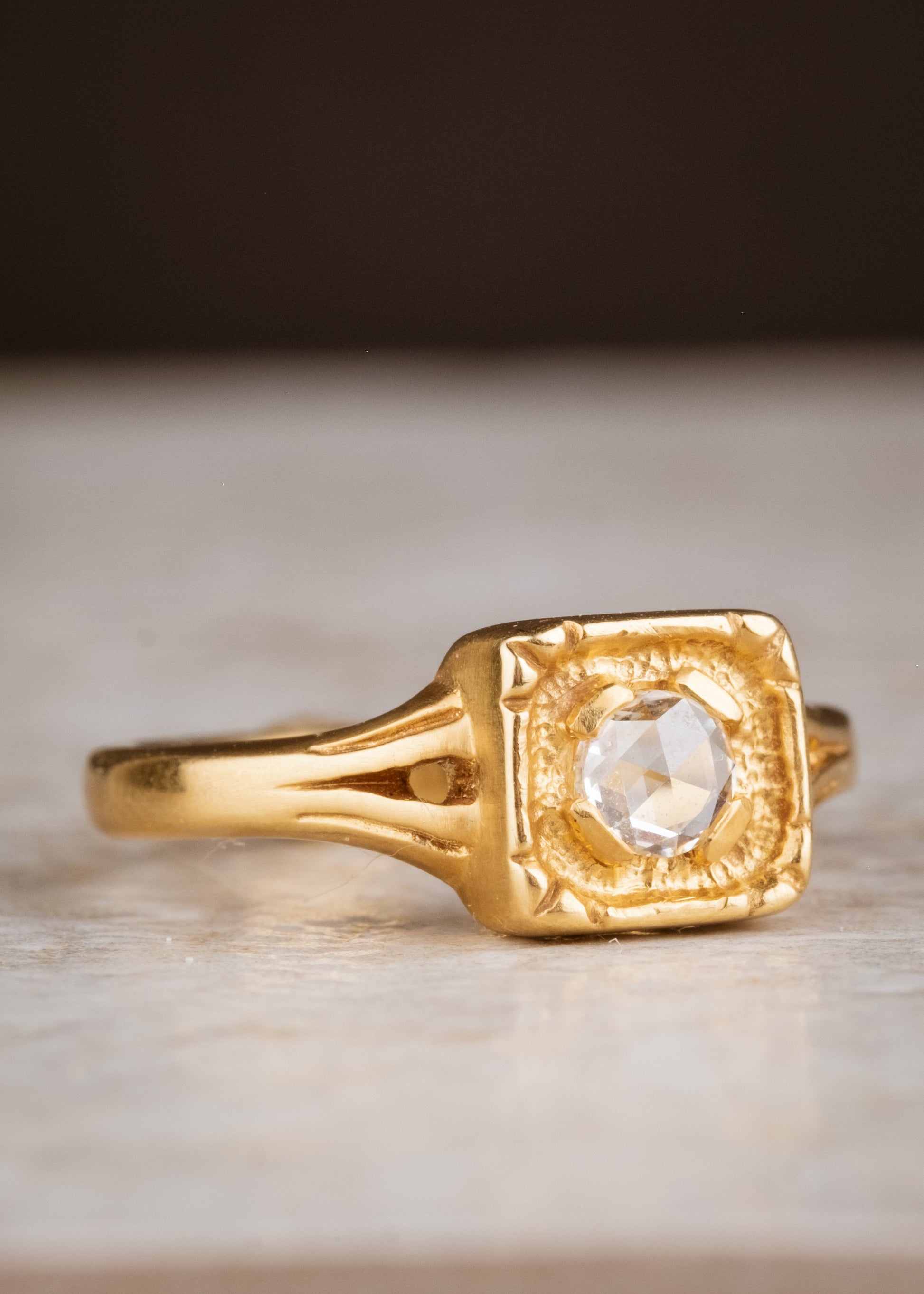 Modern lines intersect with an antique aesthetic to create the Chamber ring, a square setting of textured gold that houses a recessed rose cut diamond— strong and substantial, a meaningful connection to the past and present. 