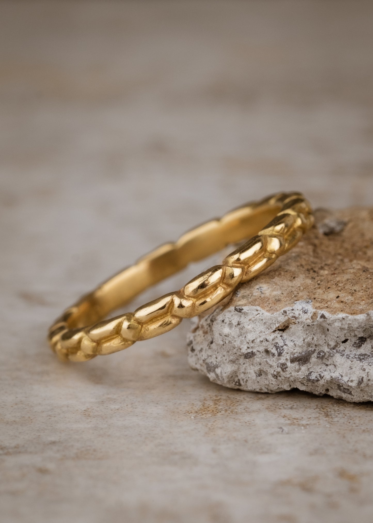 An intricately carved gold band, the Lariat ring is a study in texture—a classic piece rich in craftsmanship.