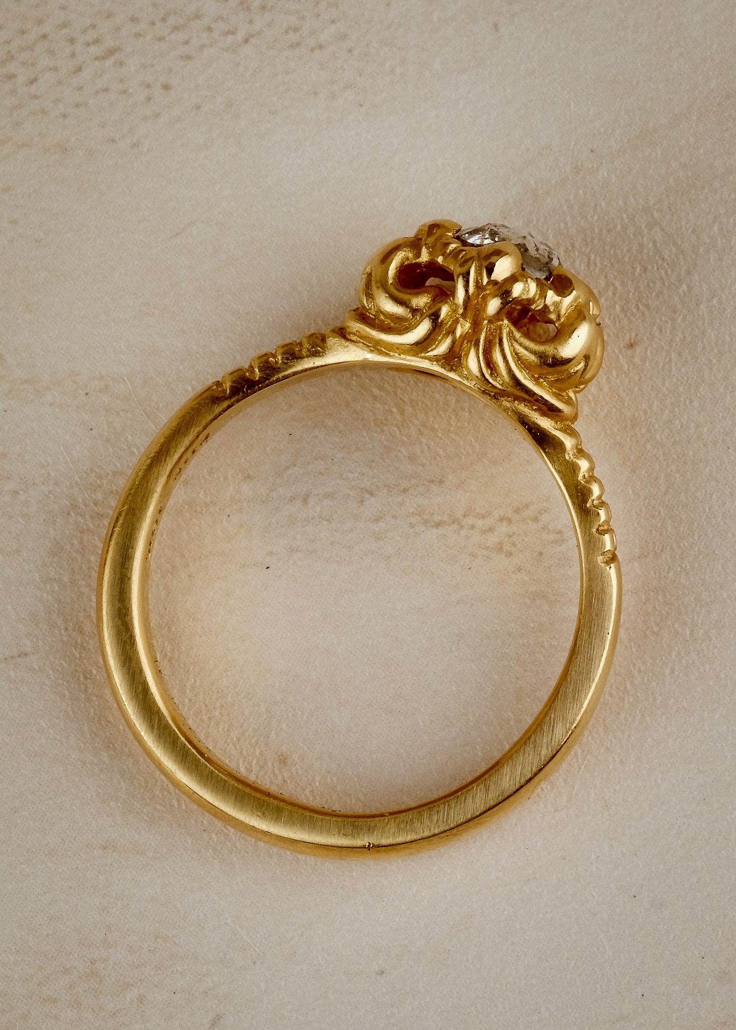 A mythical creature who continues to captivate the imagination, Lilith’s hair was referred to by the poet Rosetti as “the first gold.” A gleaming rose cut diamond is set among an intricately detailed gold band—an homage to Lilith’s ability to cast her spell wherever she goes.