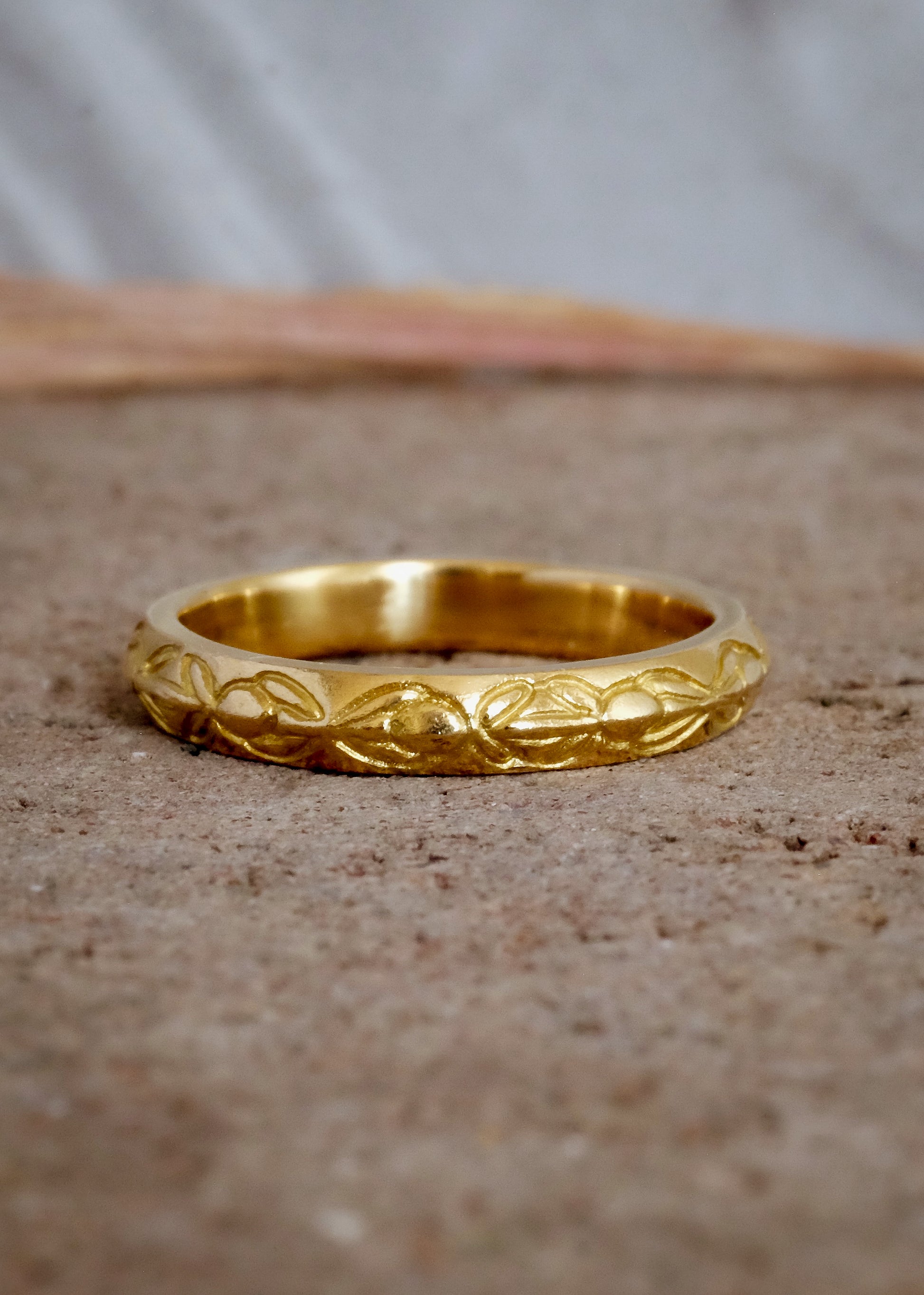 Inspired by the Aramiac word for “twin,” the Tomi ring was originally designed for a customer who requested two bands that shared deep similarities, yet claimed their own unique beauty. Hand-carved beads are connected with gently sloping lines, creating a pattern reminiscent of a delicate chain of flowers.