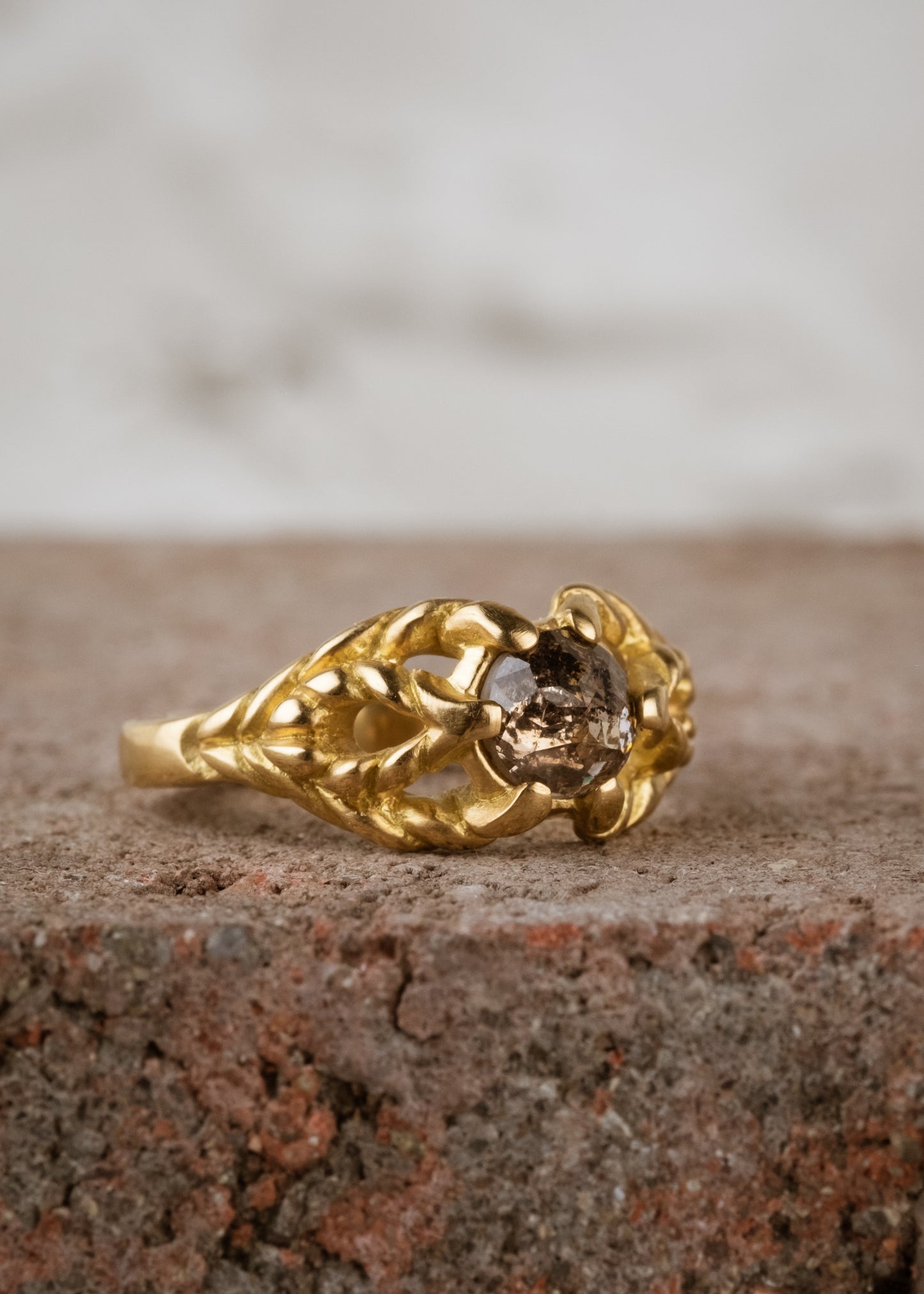 Featuring hand-carved gold that twists and turns to create a rope-like look, the Twine ring holds a stunning rose cut diamond— a piece that embodies strength, grace and beauty.