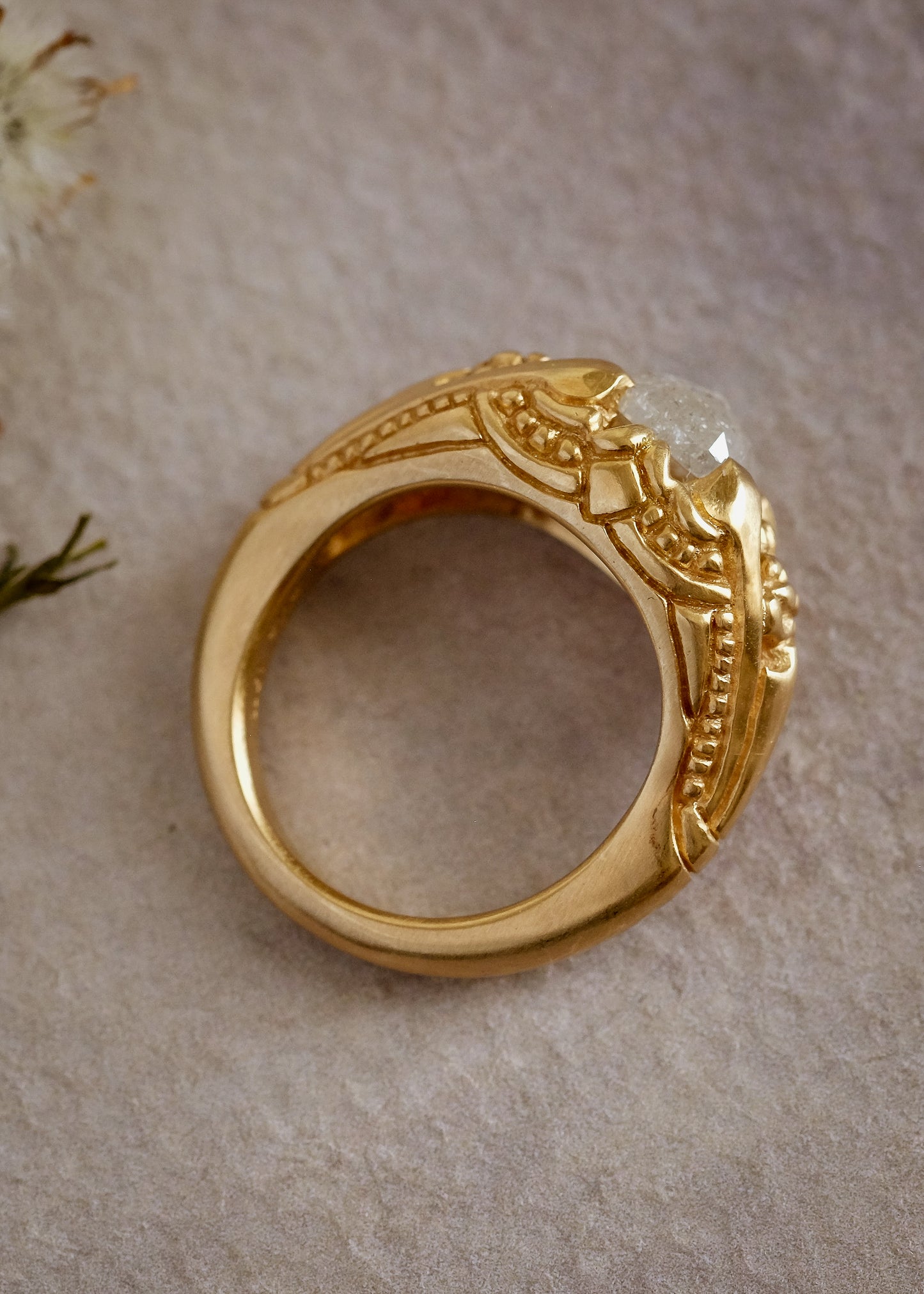 Capturing the ornate details of the Victorian era, the Violette ring was inspired by the love between Prince Albert and Queen Victoria. A substantial gold band is rich in intricate detail, showcasing craftsmanship with each bead, curve and open space. A stunning rose cut diamond sits flush among the prongs, creating a romantic ring to cherish for the ages.