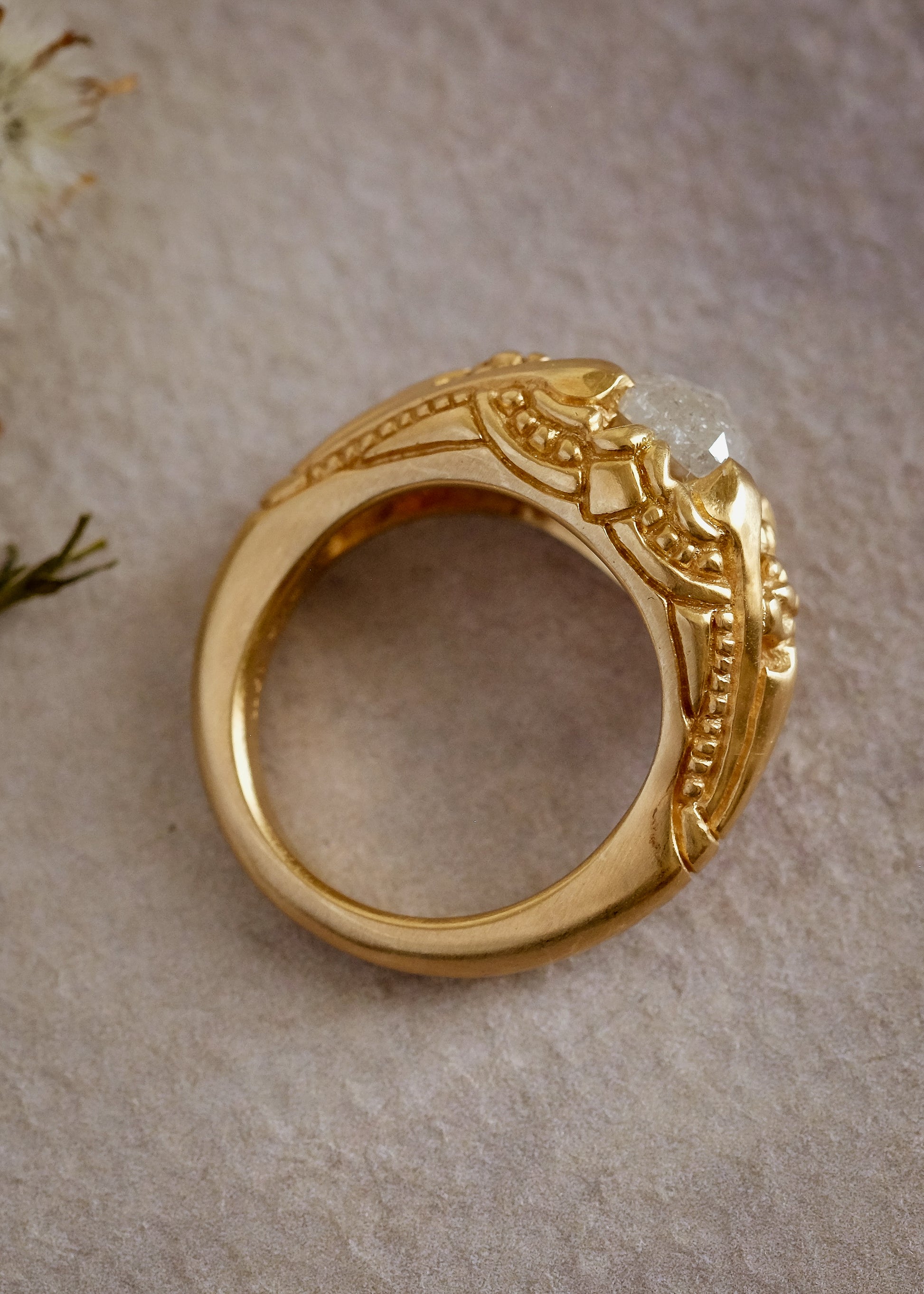 Capturing the ornate details of the Victorian era, the Violette ring was inspired by the love between Prince Albert and Queen Victoria. A substantial gold band is rich in intricate detail, showcasing craftsmanship with each bead, curve and open space. A stunning rose cut diamond sits flush among the prongs, creating a romantic ring to cherish for the ages.