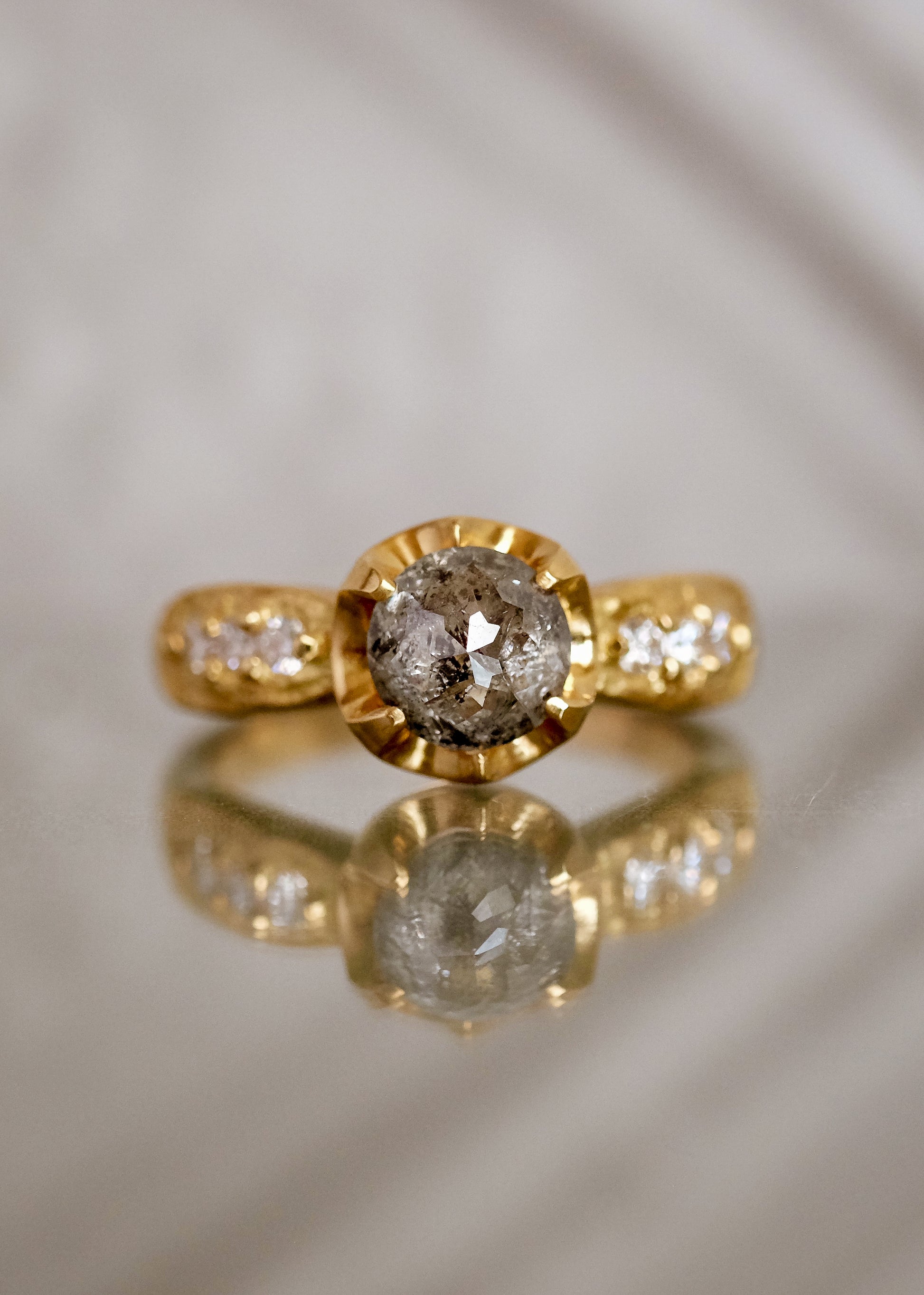 Inspired by the mesmerizing solo by musician Maxence Cyrin, the Gradiva ring embodies both the resonant chords and whimsical trills of the piano in a piece that marries substance with ethereal beauty. Brilliant inlaid diamonds adorn the band of the ring as a precious rose cut diamond sits prominently within the gold prongs—an heirloom-worthy ring to be cherished for generations.