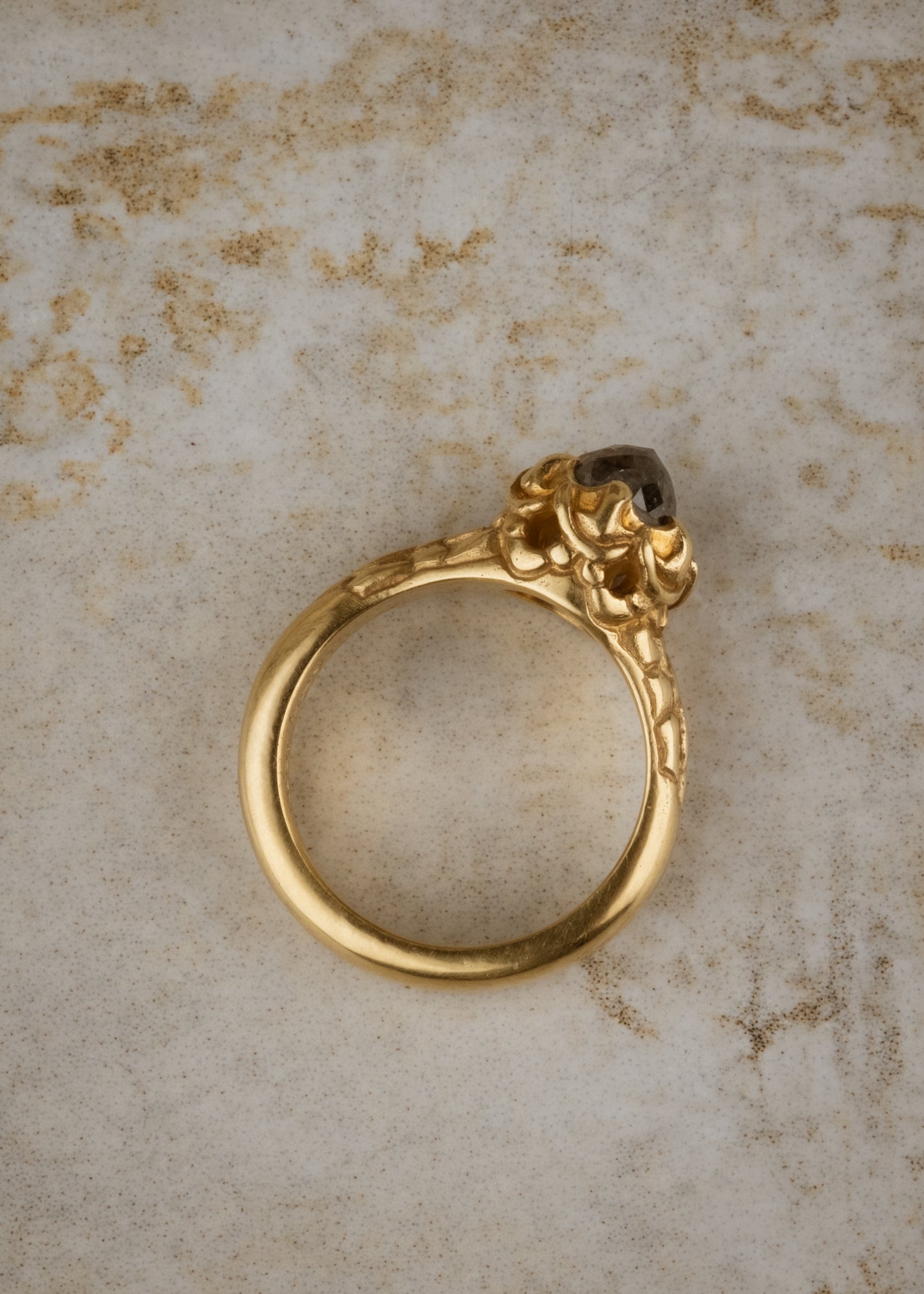A celebration of craftsmanship, the Jubilee ring is hand-carved to bring out intricate elements in the band of gold, marrying substance with he supernal and revealing a rose cut diamond that mesmerizes with its depth and dimension.