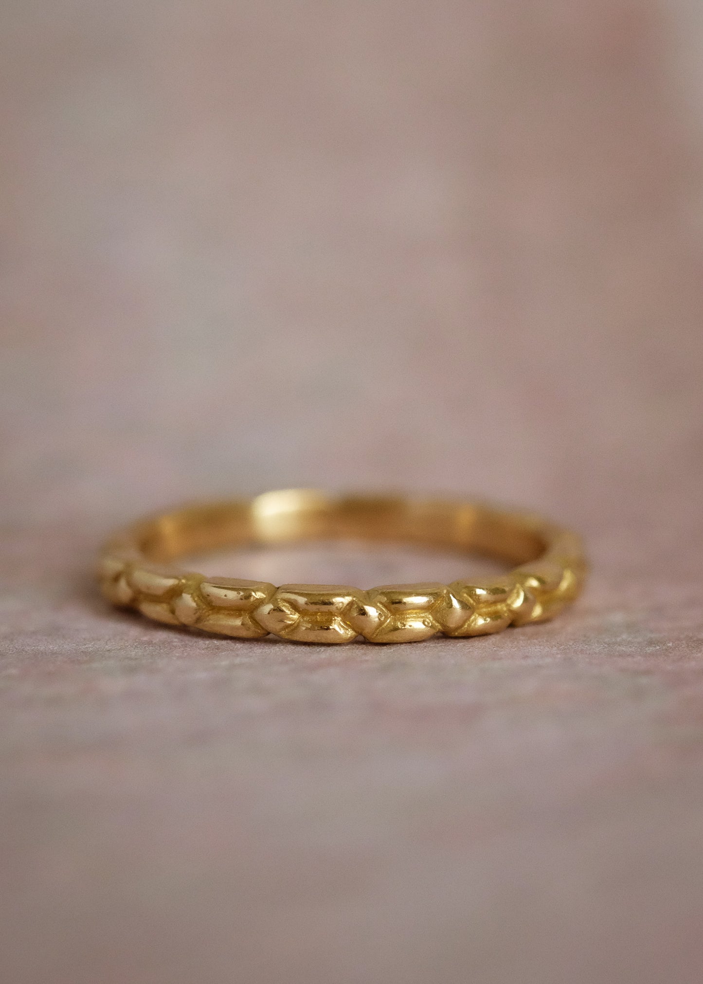 An intricately carved gold band, the Lariat ring is a study in texture—a classic piece rich in craftsmanship.