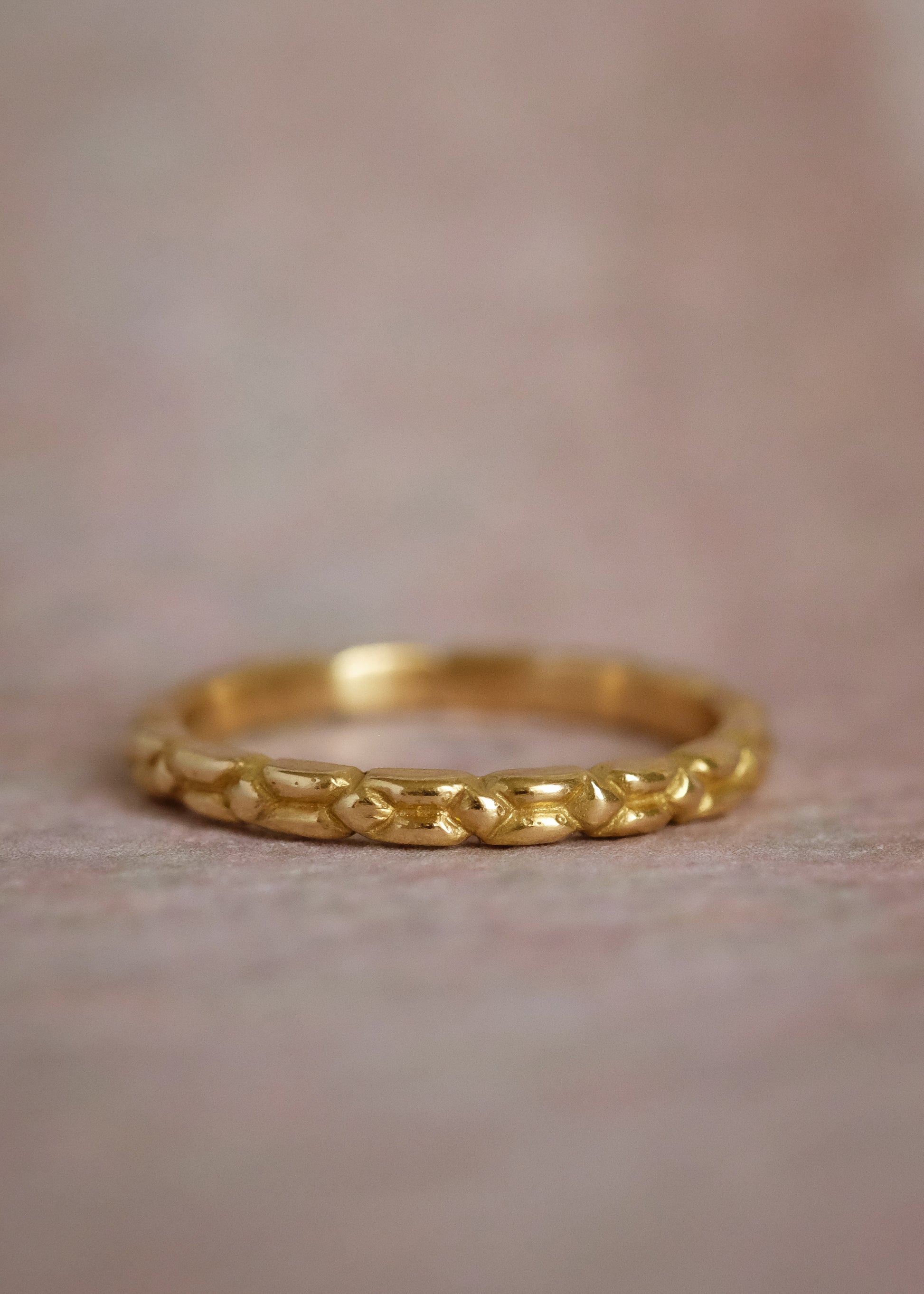 An intricately carved gold band, the Lariat ring is a study in texture—a classic piece rich in craftsmanship.