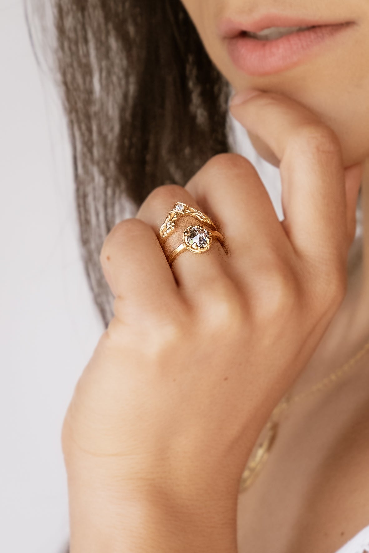 Created for a friend to perfectly compliment her engagement ring, the Empress is a nesting ring that evokes a priceless tiara. A diamond sits high atop an arched band, hand-carved with intricate detail. Two smaller diamonds sparkle on either side, creating a timeless and cherished heirloom.
