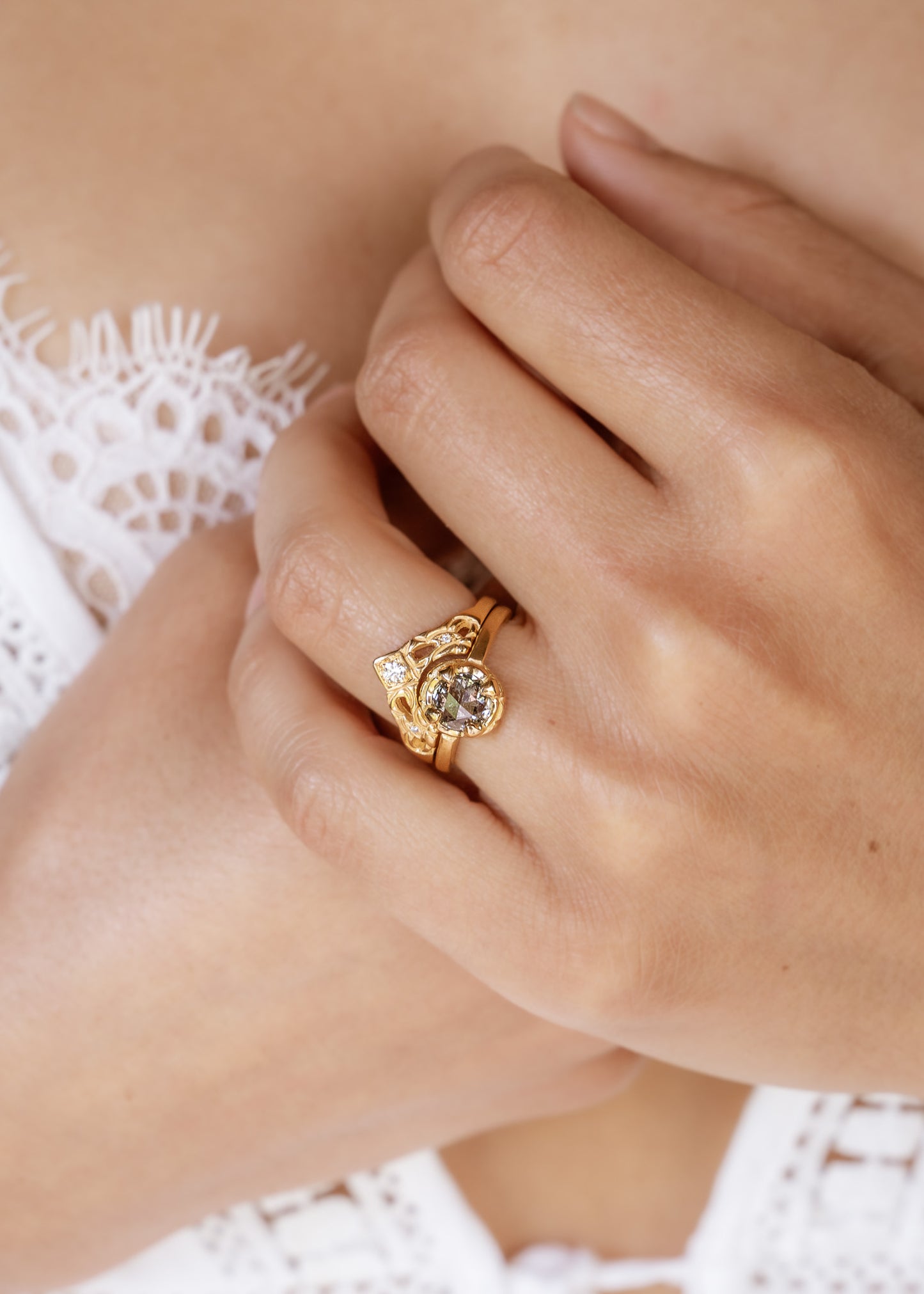 Created for a friend to perfectly compliment her engagement ring, the Empress is a nesting ring that evokes a priceless tiara. A diamond sits high atop an arched band, hand-carved with intricate detail. Two smaller diamonds sparkle on either side, creating a timeless and cherished heirloom.