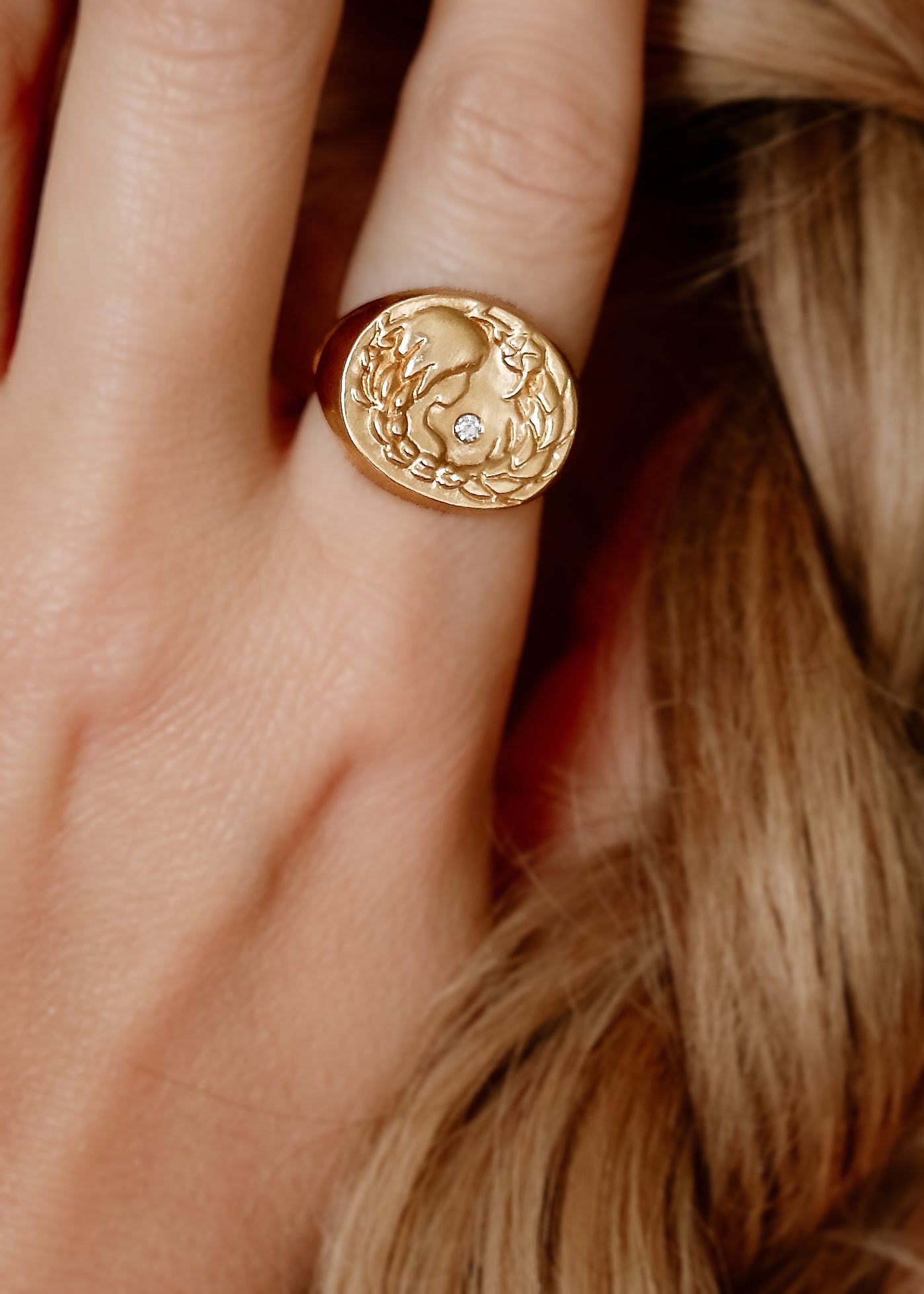 The sixth sign of the Zodiac, Earth sign Virgo is a tender humanitarian of strong character with an unparalleled eye for detail. A hand-carved goddess—surrounded by flowers and wearing a braid that turns into a sheaf— is accented with a precious diamond for a ring that captures the power of the celestial sky.