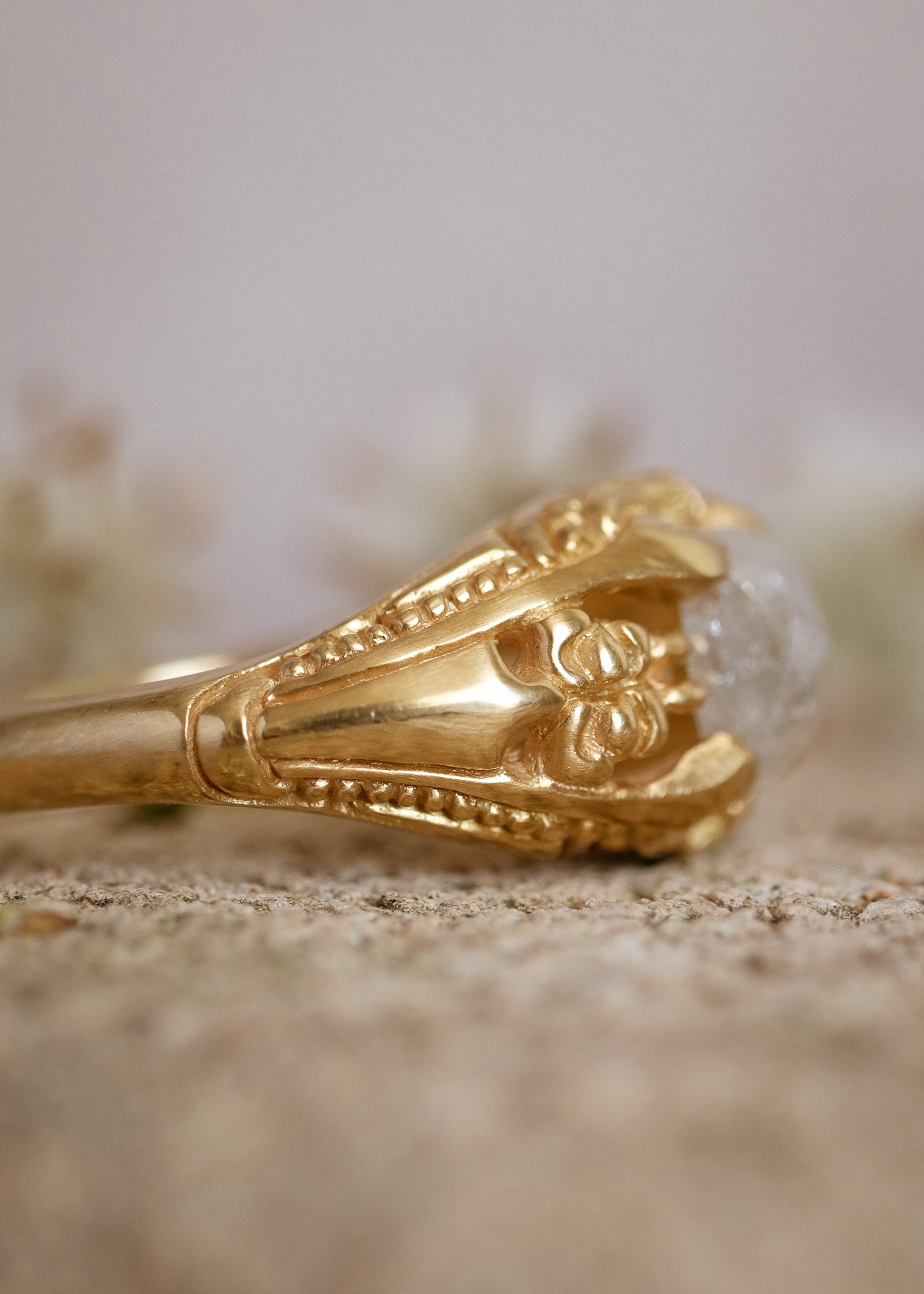 Capturing the ornate details of the Victorian era, the Violette ring was inspired by the love between Prince Albert and Queen Victoria. A substantial gold band is rich in intricate detail, showcasing craftsmanship with each bead, curve and open space. A stunning rose cut diamond sits flush among the prongs, creating a romantic ring to cherish for the ages.