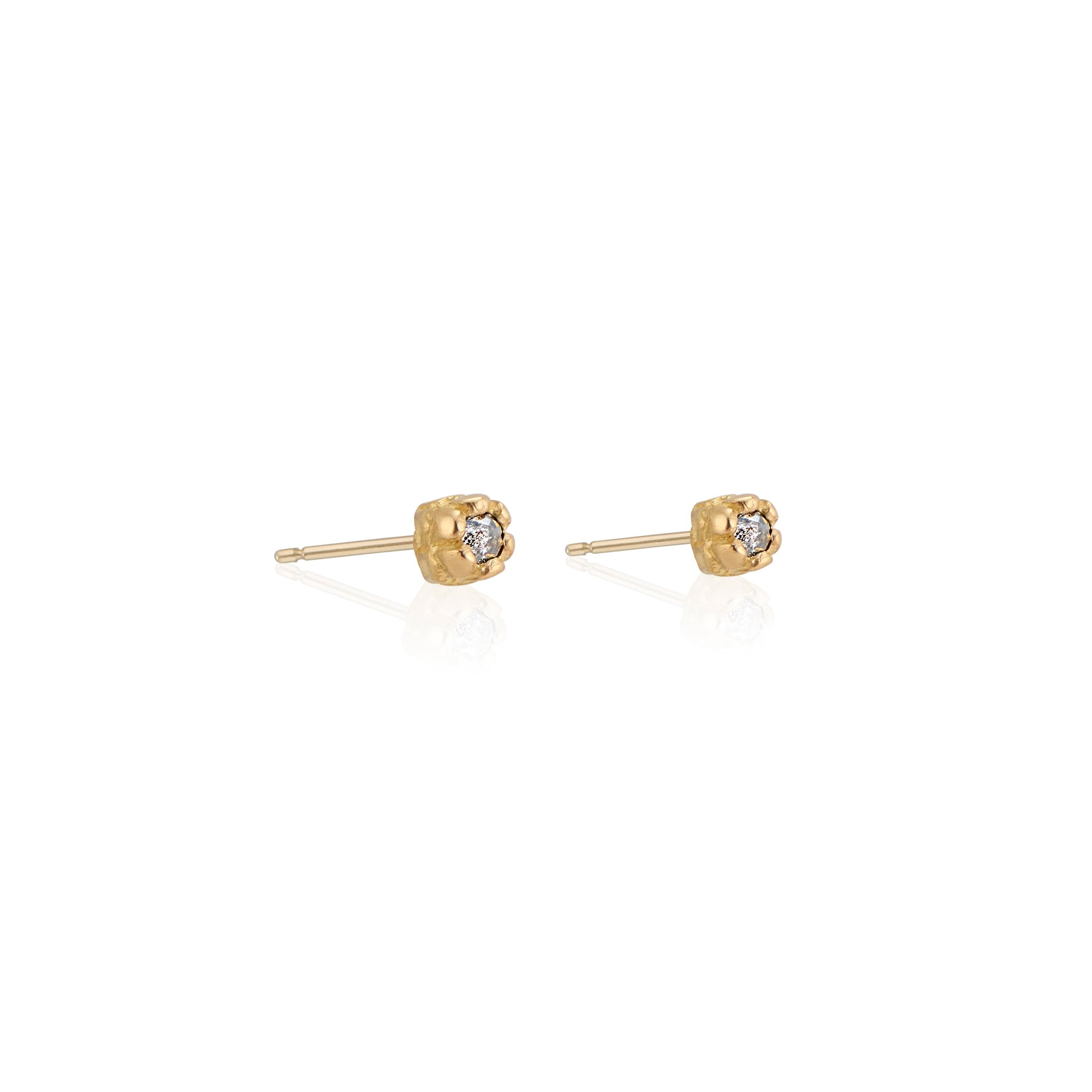 Inspired by a set of rings purchased for a childhood crush, the Bey earrings merge the simplicity of days past with a refined sophistication. Hand-crafted gold petals form a cocoon around a stunning rose cut diamond, creating delicate earrings perfect for celebrating the everyday. 