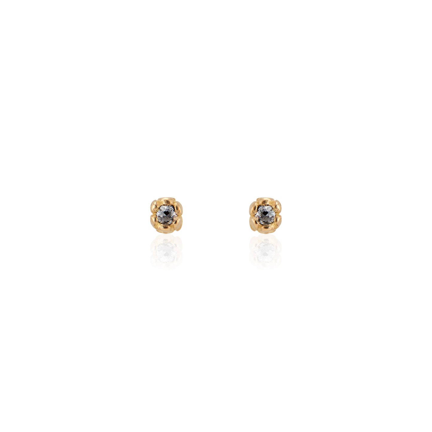 Inspired by a set of rings purchased for a childhood crush, the Bey earrings merge the simplicity of days past with a refined sophistication. Hand-crafted gold petals form a cocoon around a stunning rose cut diamond, creating delicate earrings perfect for celebrating the everyday. 