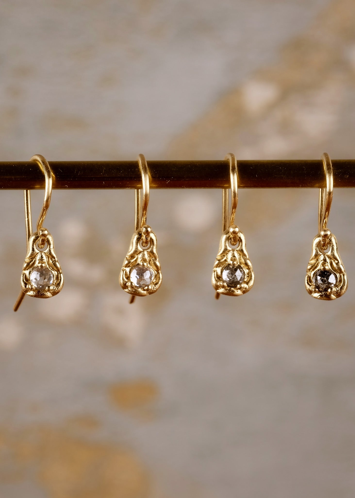 Inspiration, found. These delicate earrings gleam in hand-carved gold, their intricate pattern playing up the rose cut diamonds that shine from their center–a beacon for the Muses to bestow knowledge and creativity.