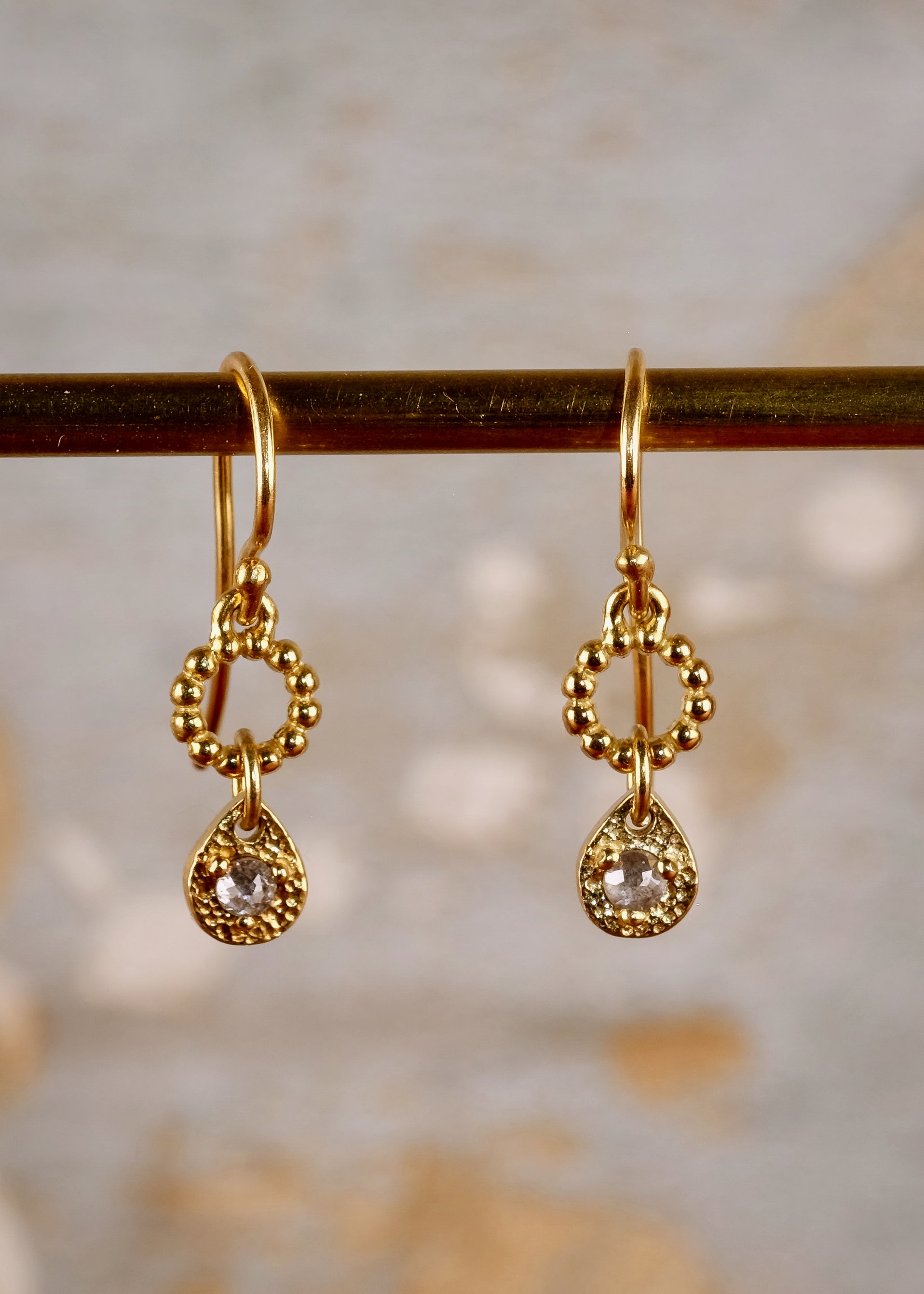 A romantic journey that transcends time. The Drop earring merges a circle of understated gold beads with ornate rose cut diamonds for a dangling romantic style that feels as at home today as it does in an antique jewelry box. 