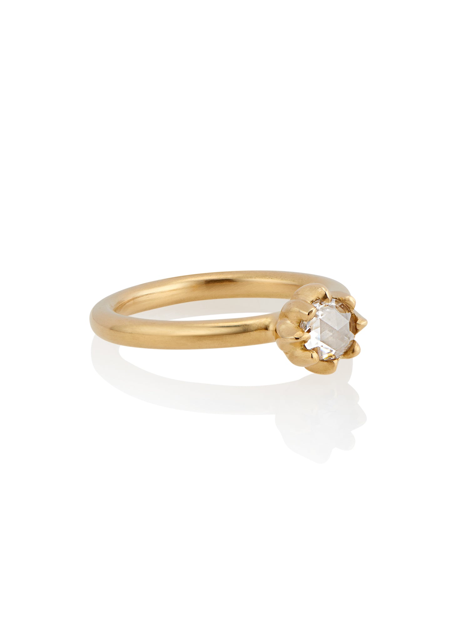 In simplicity, majesty is revealed. Inspired by the stark and graphic botanical photographs of Karl Blossfeldt, the Fleur ring creates a striking silhouette on the finger, its clean gold band showcasing a regal and romantic rose cut diamond. 