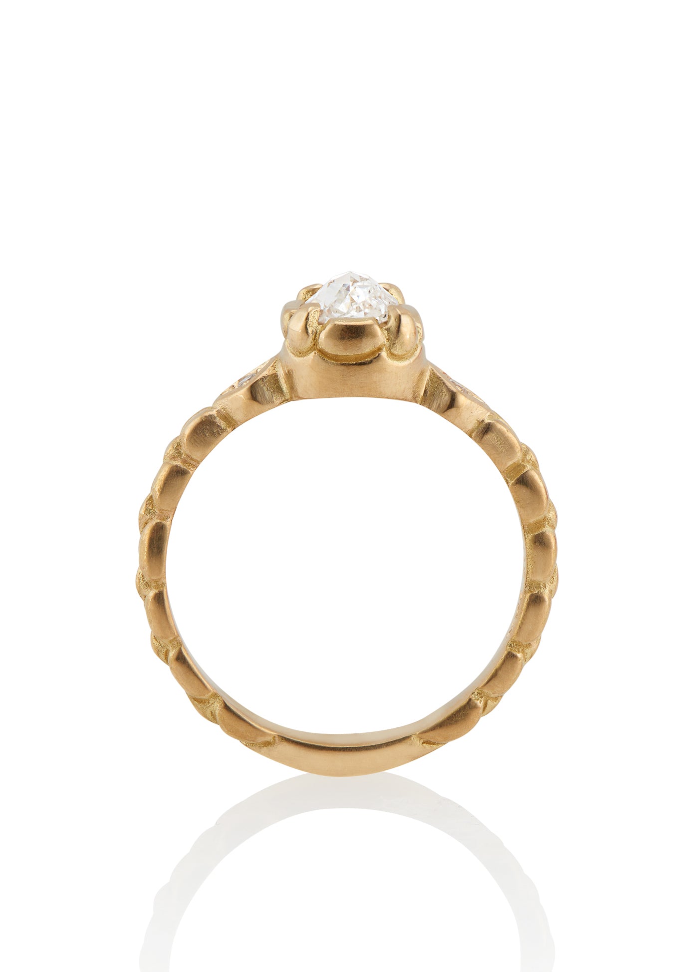 Stately and elegant, the Majestic ring is rich in exquisitely carved gold detail along the band, securing a pear-shaped rose cut diamond that commands attention—a piece evocative of royalty. 
