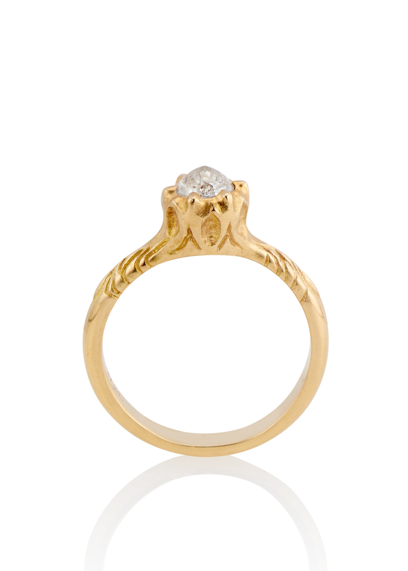 Like the haunting notes of a Glenn Miller Orchestra record, the Perfidia ring ascends to prominence on the finger to captivate all who bear witness to such beauty. Delicate details on the gold band give way to a textured pattern that holds a rose cut diamond, an exquisite work of ornate craftsmanship. 