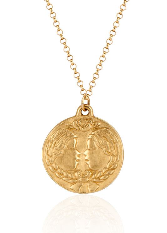 The third sign of the Zodiac, air sign Gemini is quick-witted and curious, with a dual personality that reflects an open mind. Hand-carved twins, bound together by a ribbon, grace this pendant—a necklace that captures the power of the celestial sky. 