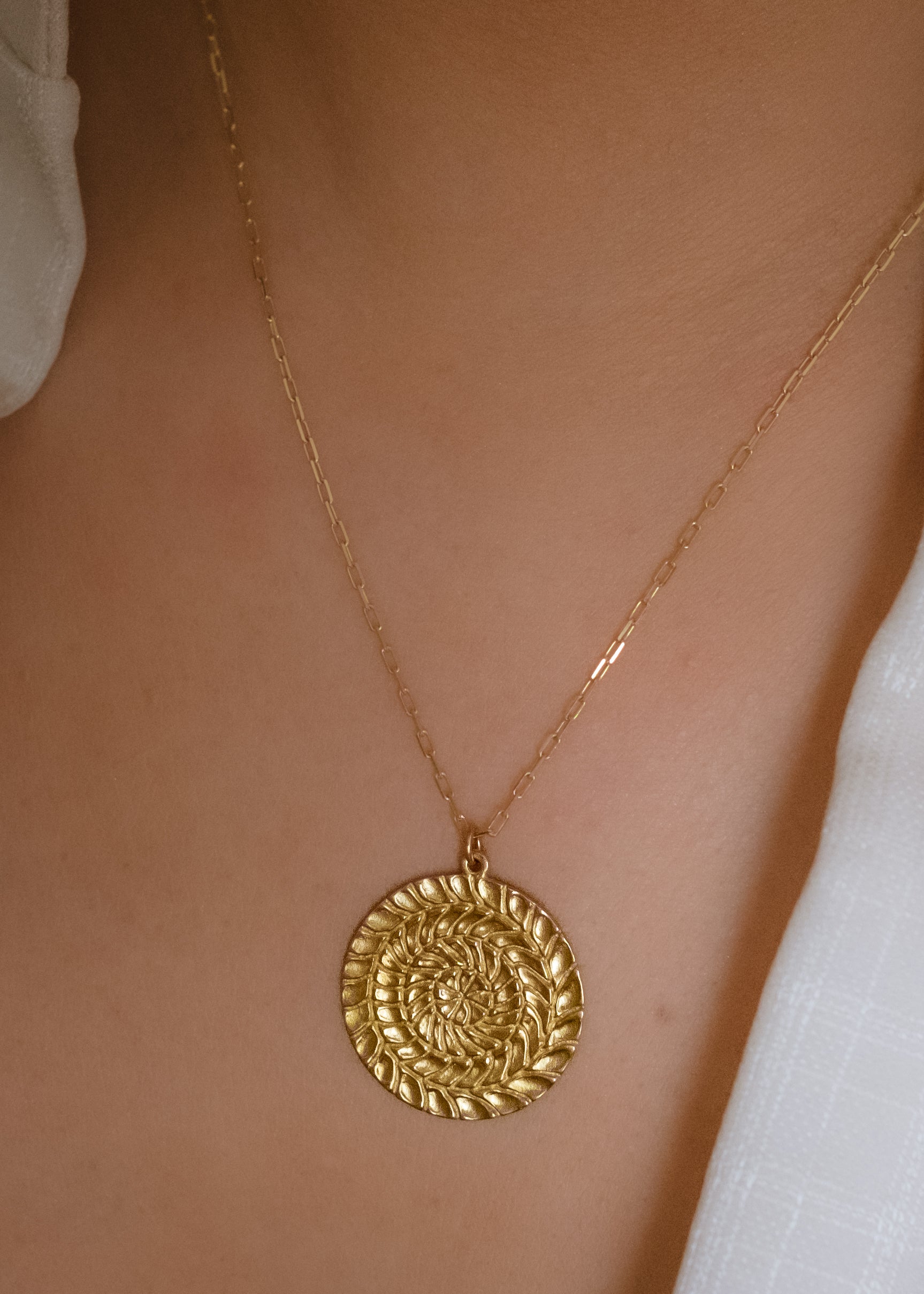 Named for Busby Berkely’s wife, the Etta necklace is a kaleidoscopic wonder that mirrors his elaborate geometric choreography. Four concentric circles, each detailed by hand, create a hypnotic and substantial pendant necklace as timeless as Berkeley’s black and white films. 