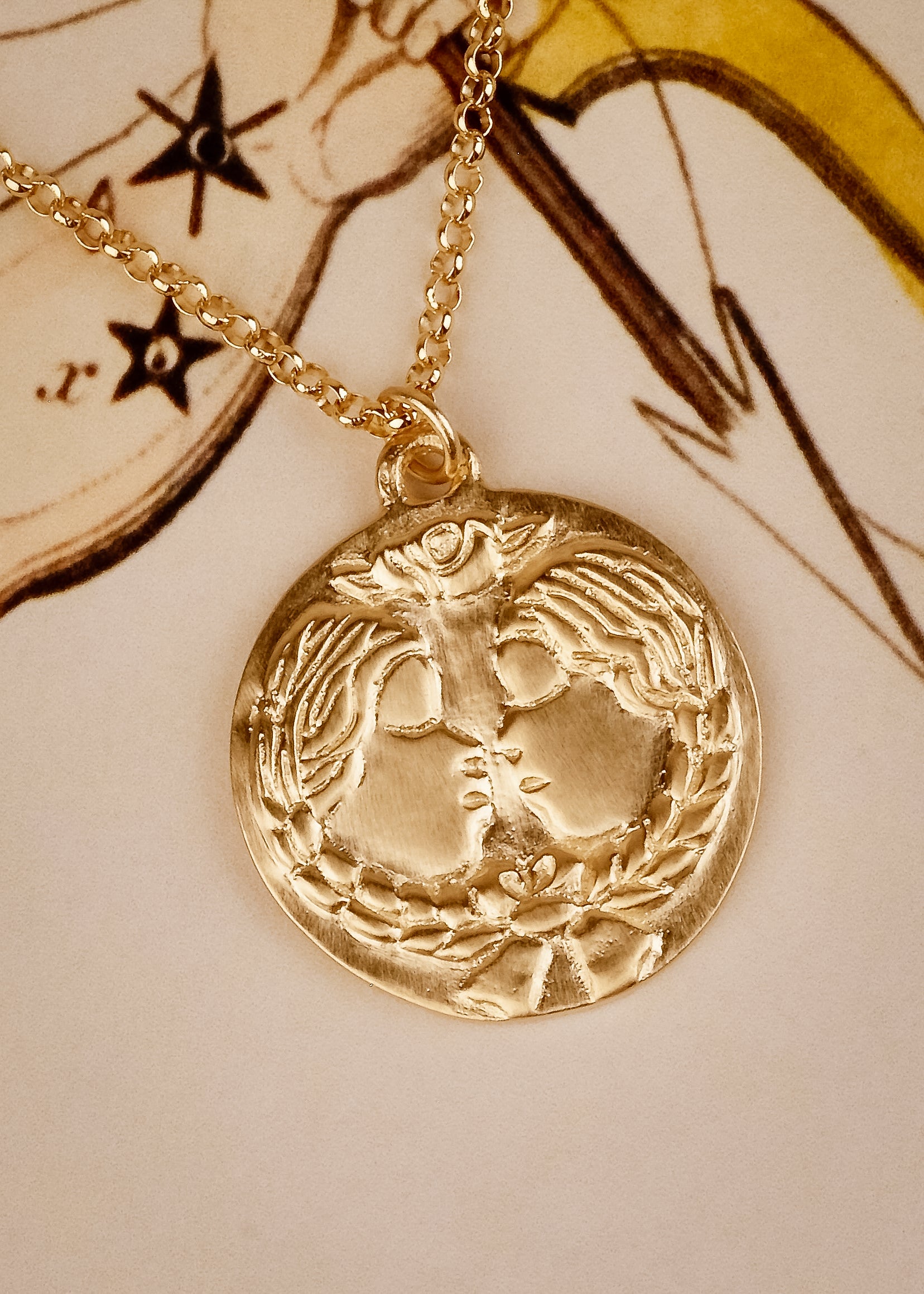 The third sign of the Zodiac, air sign Gemini is quick-witted and curious, with a dual personality that reflects an open mind. Hand-carved twins, bound together by a ribbon, grace this pendant—a necklace that captures the power of the celestial sky. 