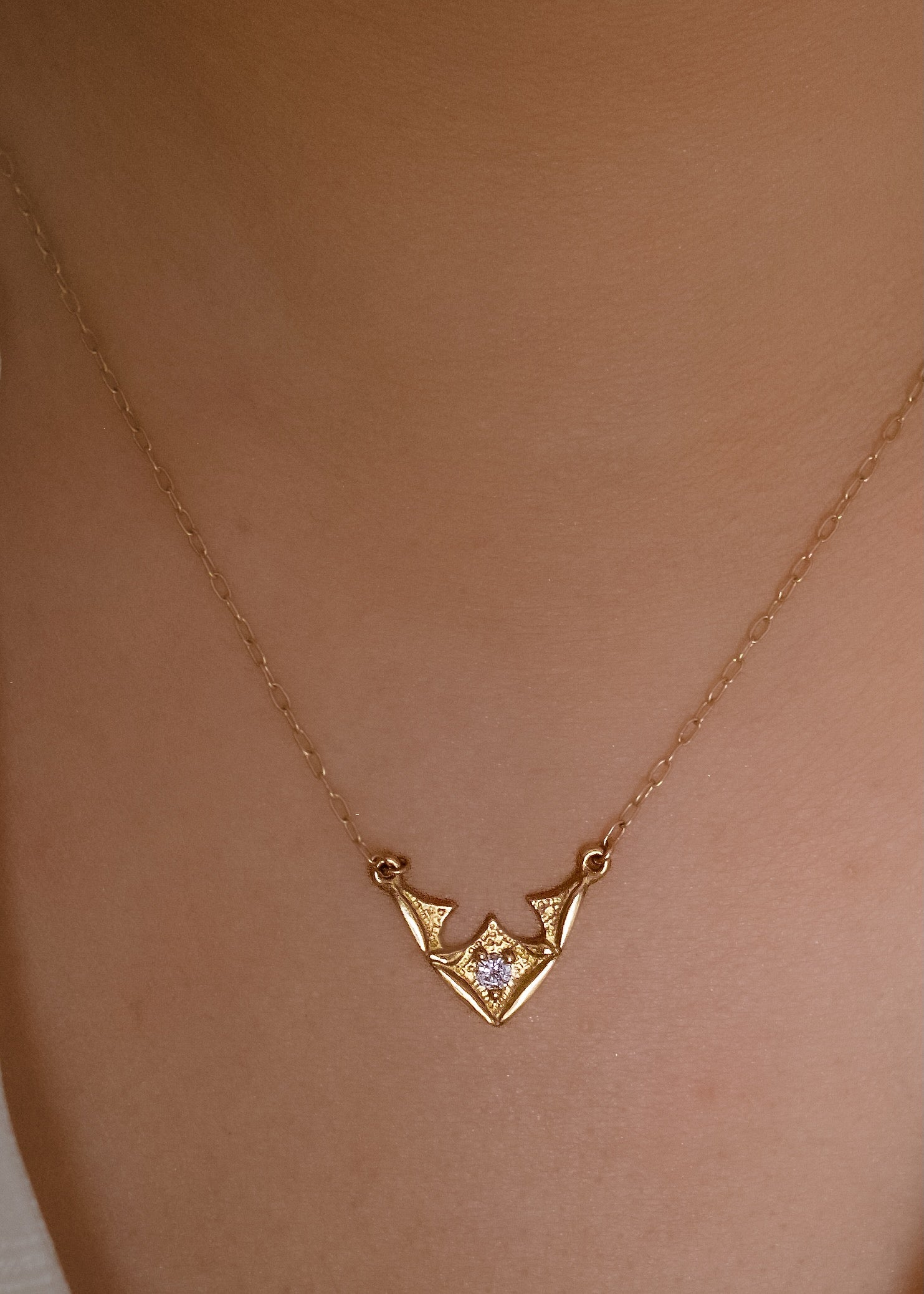 Taken from the French word for “vault,” the Volta necklace is an homage to the Gothic architecture of Paris. Gentle sloping curves give way to acute points, evoking the grandeur of a centuries-old cathedral ceiling. A single diamond catches the eye, complemented by ornate texture and delicate beading—a necklace that transcends time and transports the imagination.