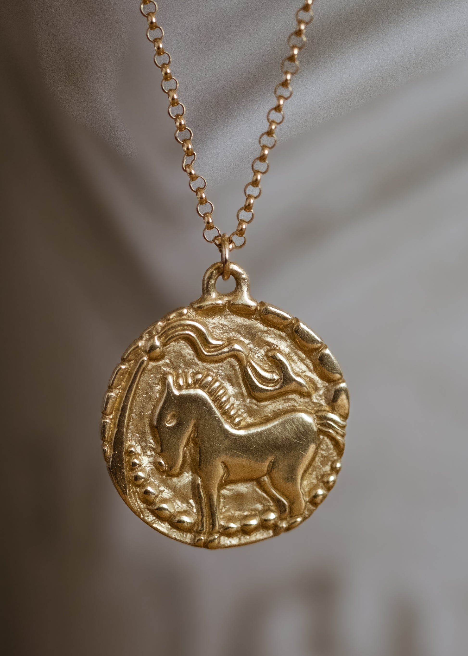 With its hand-carved horse—an embodiment of beauty and strength— and intricate detail, the Coronation necklace marries the artistry of metalwork with a spirit of whimsy and independence. A powerful totem of personal sovereignty. 