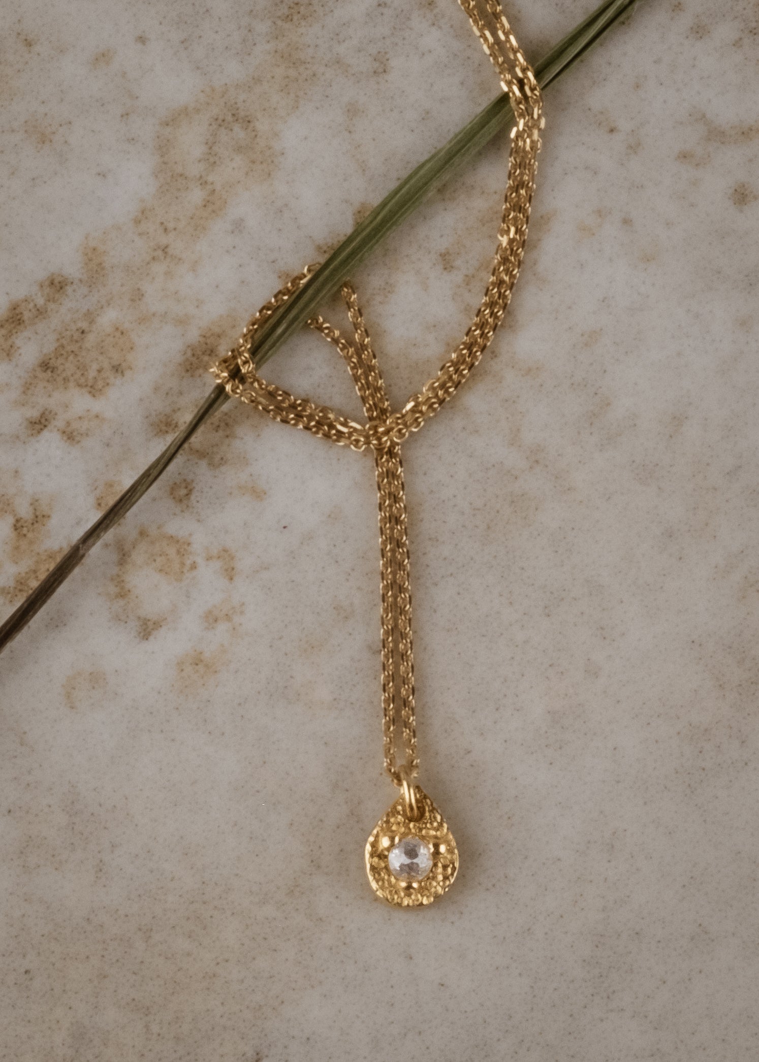 A romantic journey that transcends time. The Drop necklace merges a circle of understated hand-carved gold beads with ornate rose cut diamonds for a dangling romantic style that feels as at home today as it does in an antique jewelry box. 