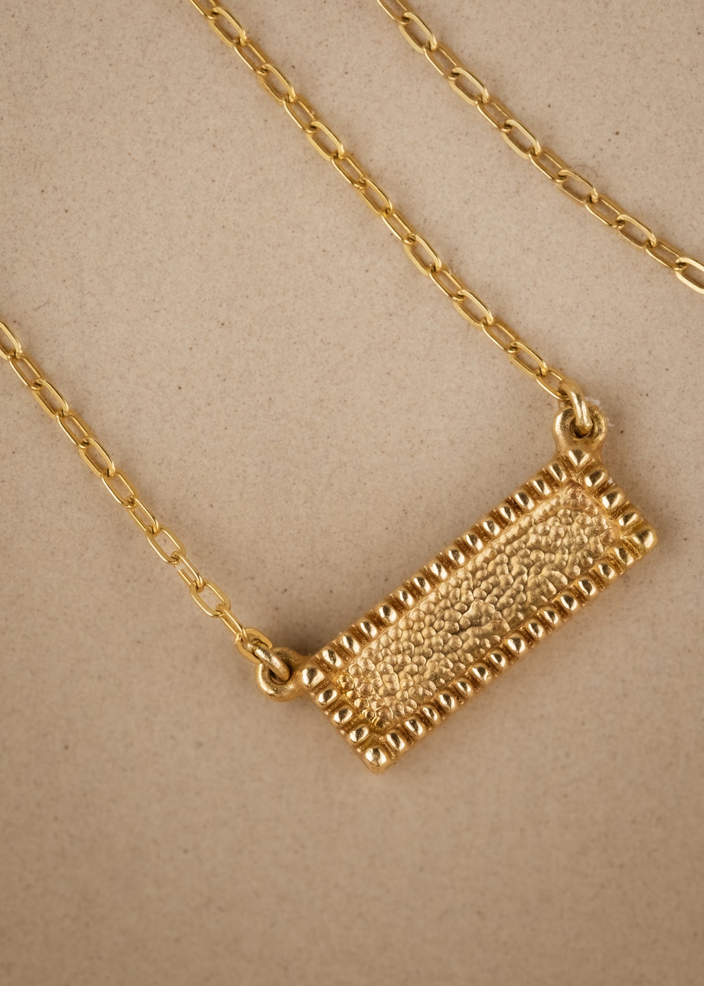 Let the details that speak to you come into focus. The Frame necklace is a study in craftsmanship, at once delicate and substantial. Beaded framework surrounds textured gold for a timeless and eye-catching necklace.