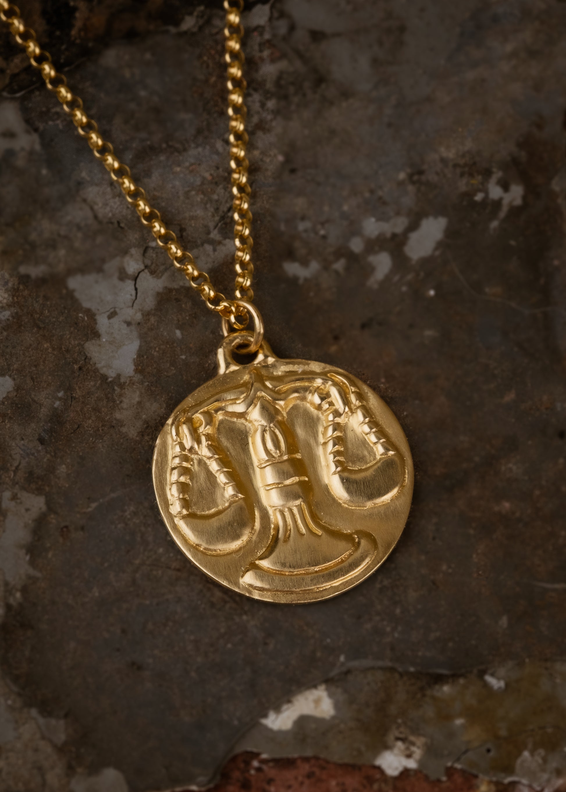 The seventh sign of the Zodiac, air sign Libra is an egalitarian peacemaker in search of harmony.  Hand-carved scales of justice grace this pendant, creating a necklace that captures the power of the celestial sky.
