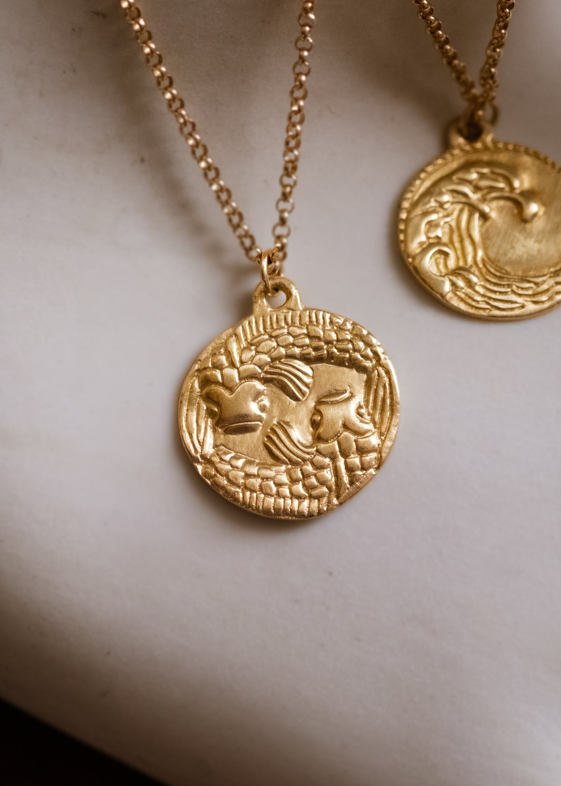 The twelfth sign of the Zodiac, water sign Pisces is a natural born helper who loves to be around others, selflessly giving without expecting in return. Hand-carved fish grace this pendant for a necklace that captures the power of the celestial sky.