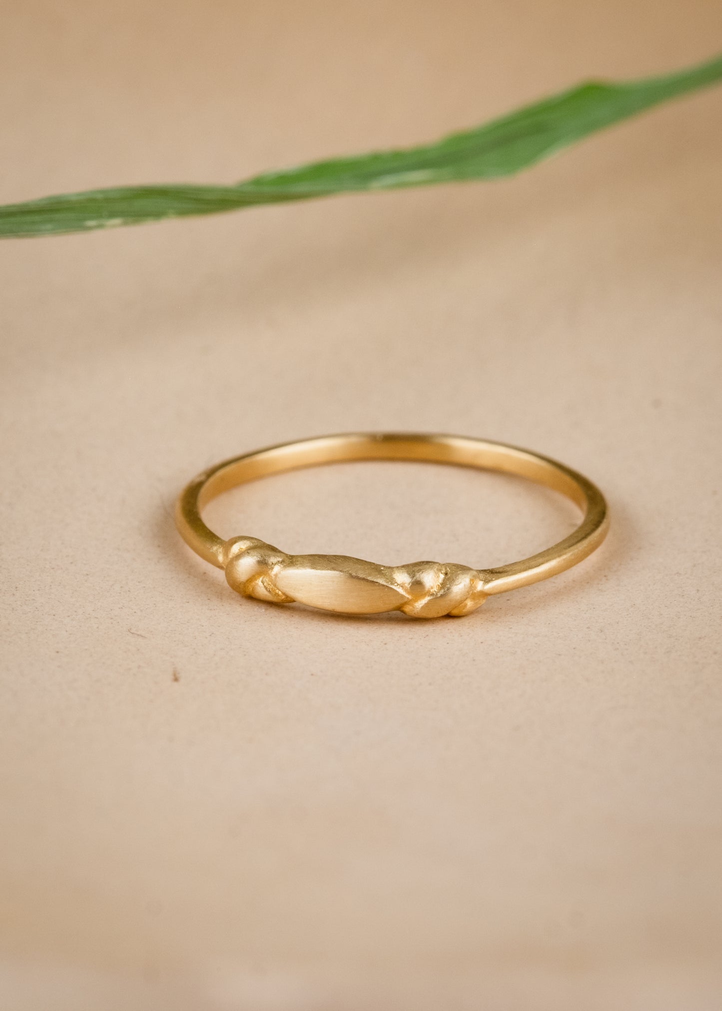 Like a cornice of a treasured landmarked building, the Bond ring features two intricate knots bonded astride a pointed oval–a dainty band ideal for everyday, for wearing solo or layering.
