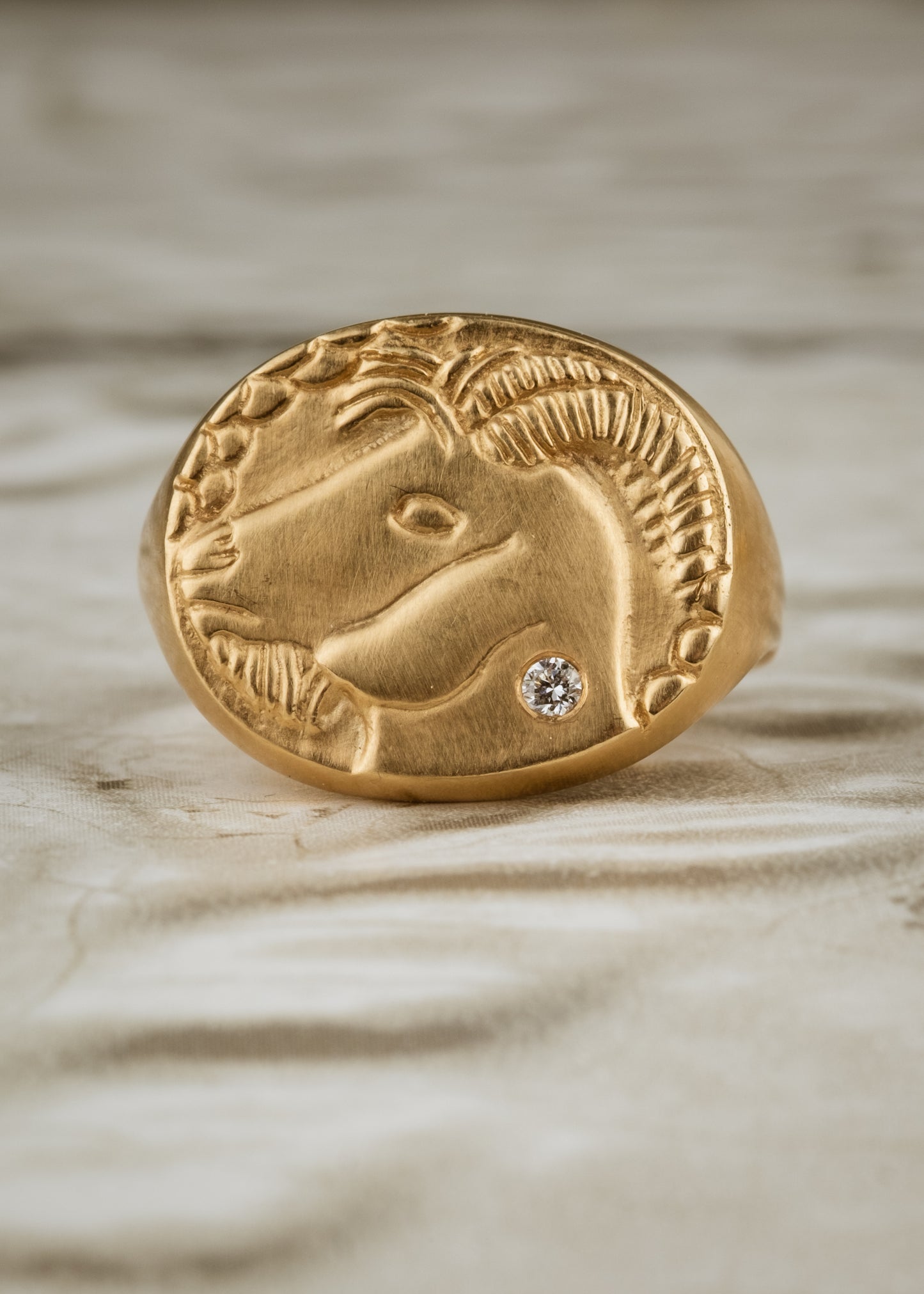 The tenth sign of the Zodiac, Earth sign Capricorn is fiercely independent and responsible, grounded in reality that they can mold to their will. A hand-carved, moody bearded goat is accented with a precious diamond for a ring that captures the power of the celestial sky.