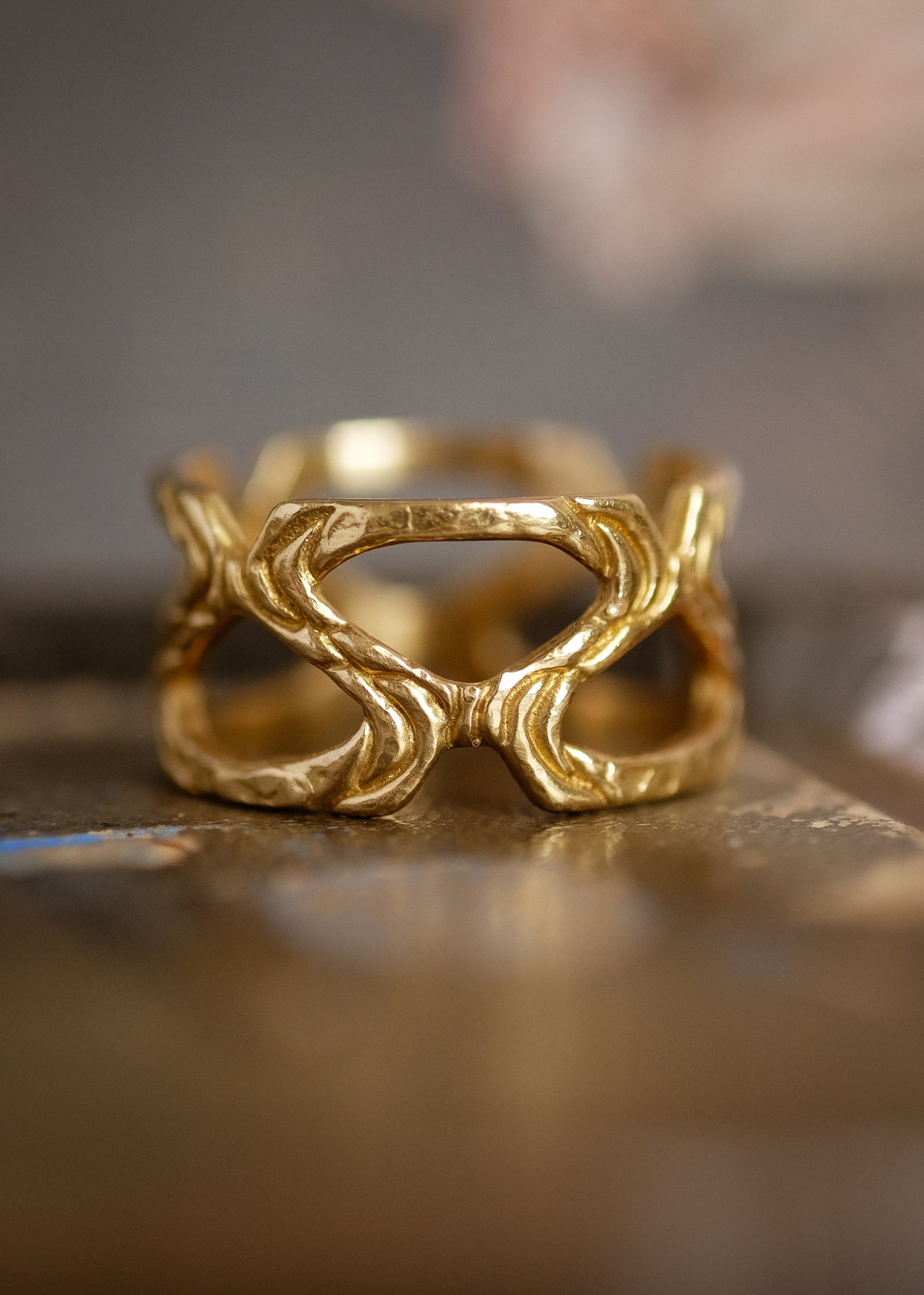 Conjuring the haunted cobblestone streets of the historic town for which it is named, the Salem ring weaves open spaces with textured gold to create a wide band for everyday wear—a bold and eye-catching piece of metalwork.