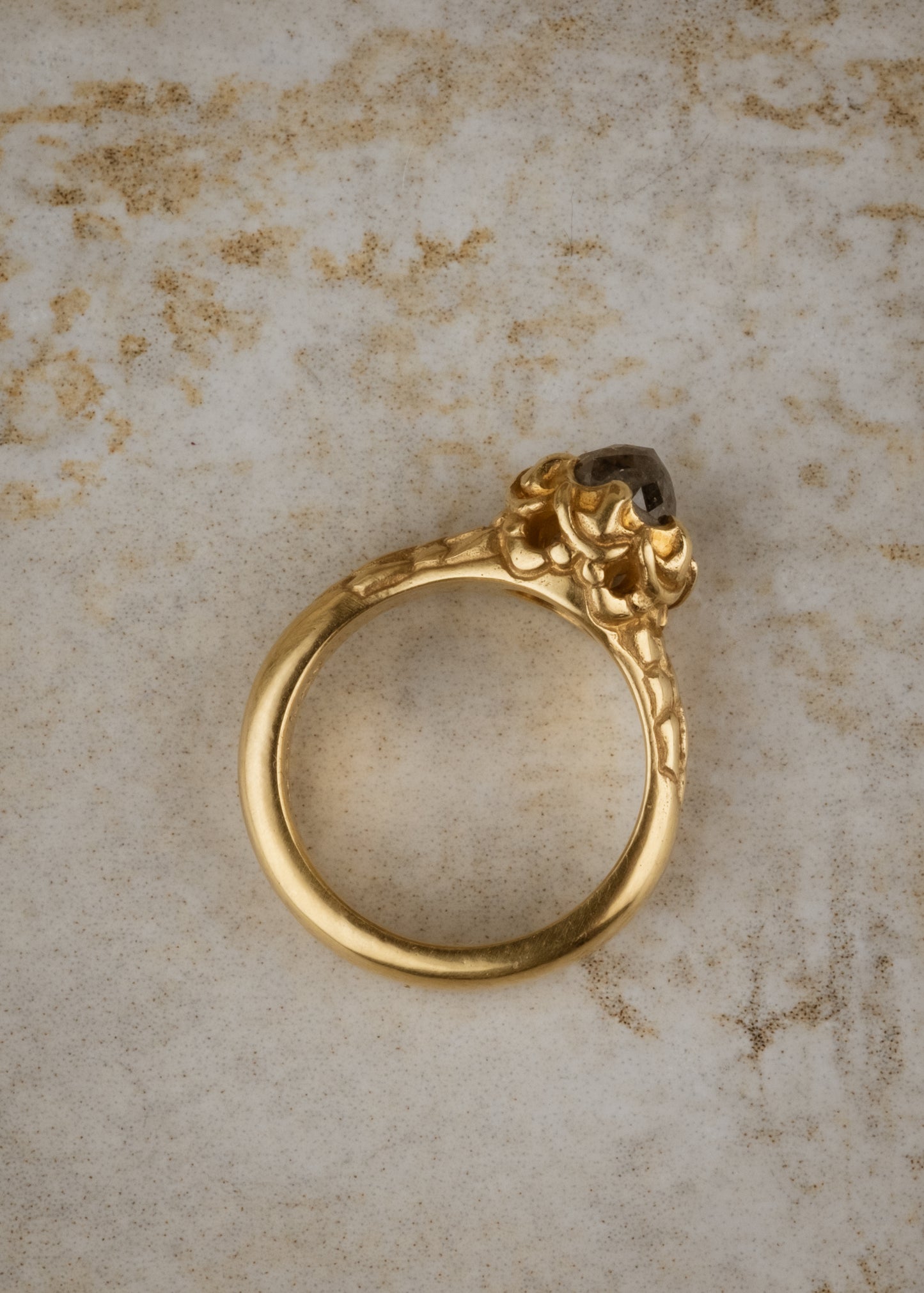 A celebration of craftsmanship, the Jubilee ring is hand-carved to bring out intricate elements in the band of gold, marrying substance with he supernal and revealing a rose cut diamond that mesmerizes with its depth and dimension. 