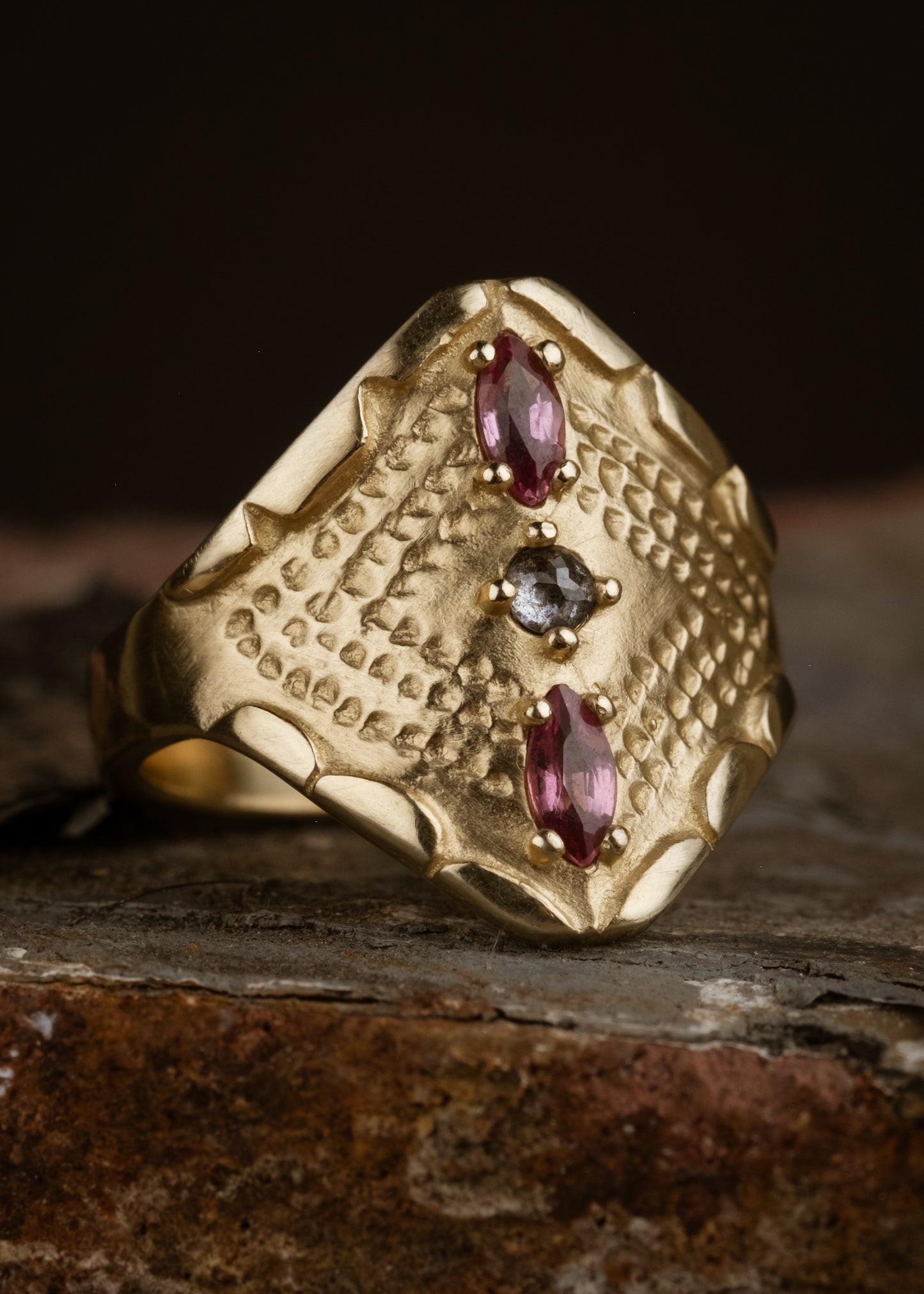 Inspired by the pointed arches in ancient cathedrals, the Radial ring marries the strength of this architectural element with the softness of the hand-carved scalloped detail along the edges. Tourmalines and a rose cut diamond align in the center of this statement ring, radiating their light along an intricate textured pattern that highlights the beauty of the gold.