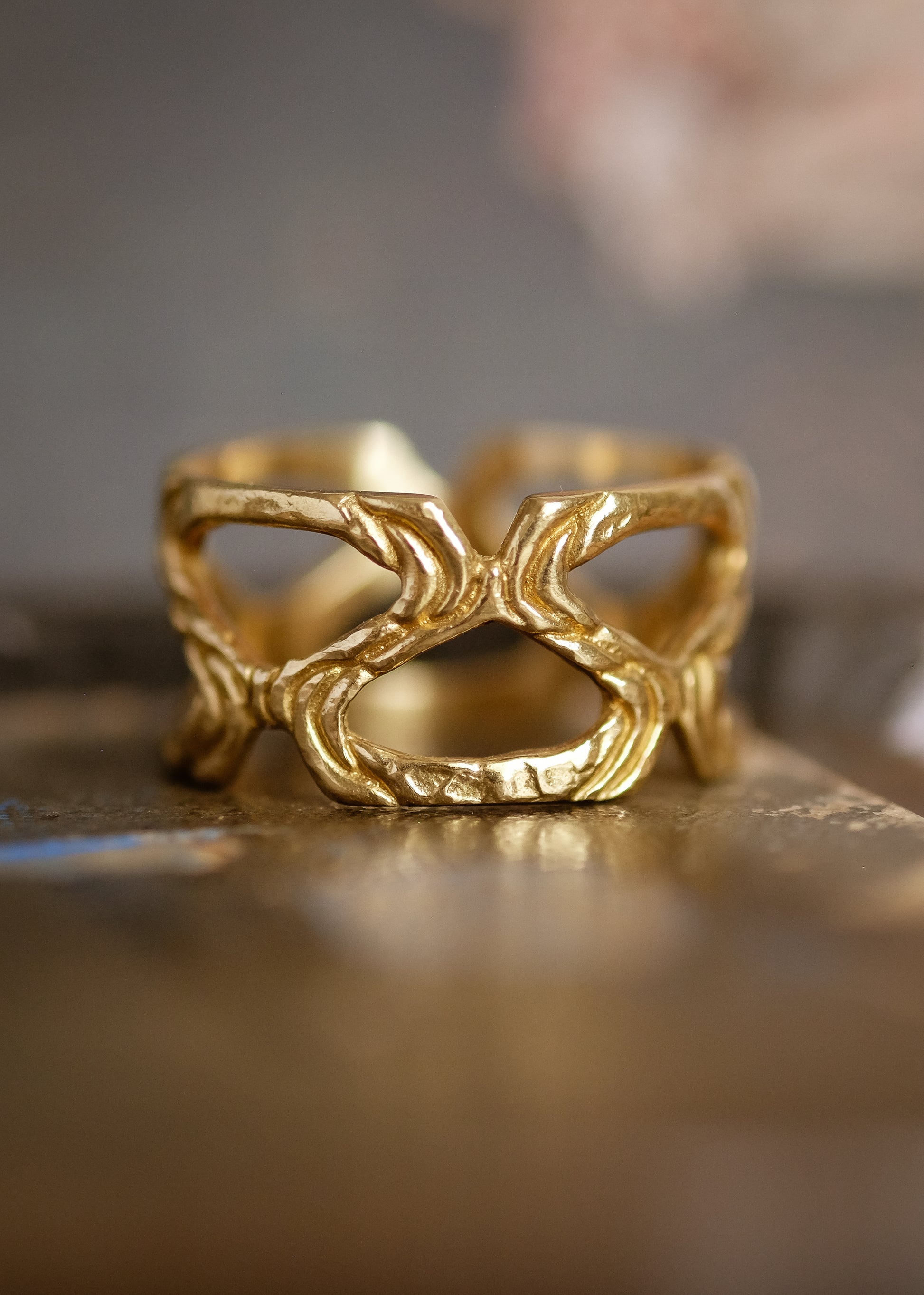 Conjuring the haunted cobblestone streets of the historic town for which it is named, the Salem ring weaves open spaces with textured gold to create a wide band for everyday wear—a bold and eye-catching piece of metalwork.